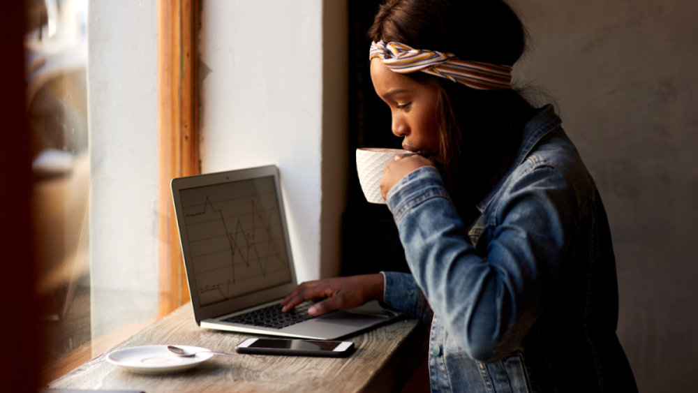 young woman on laptop drinking coffee